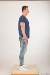 Whole body blue tshirt light blue jeans modeling a pose of Andrew